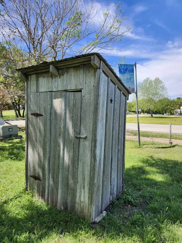 Outhouse in the far corner of the property at Lyndon Johnson's boyhood home in Johnson City, Texas.