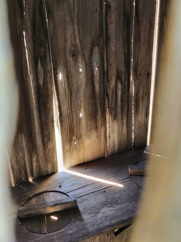 Interior of a reconstructed two-seat outhouse behind Lyndon Johnson birthplace.