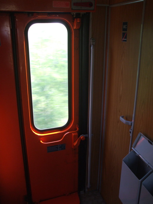 Entry to washroom next to the boarding door of EuroNight passenger train from Romania to Hungary.