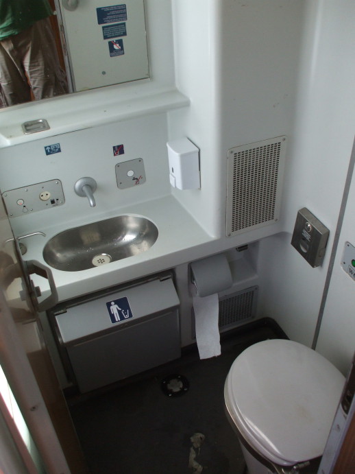 Sink and toilet in the washroom of EuroNight passenger train from Romania to Hungary.