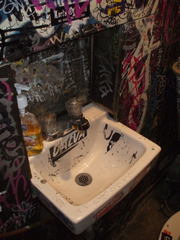 Sink in Welcome To The Johnson's Bar on Rivington Street on the Lower East Side in New York: Dial anti-bacterial soap, hot and cold knobs.