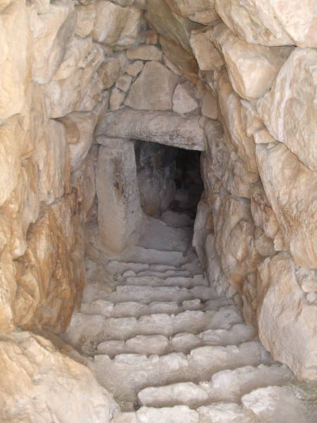 Stone tunnel staircase leading to a large underground water cistern at Mycenae.