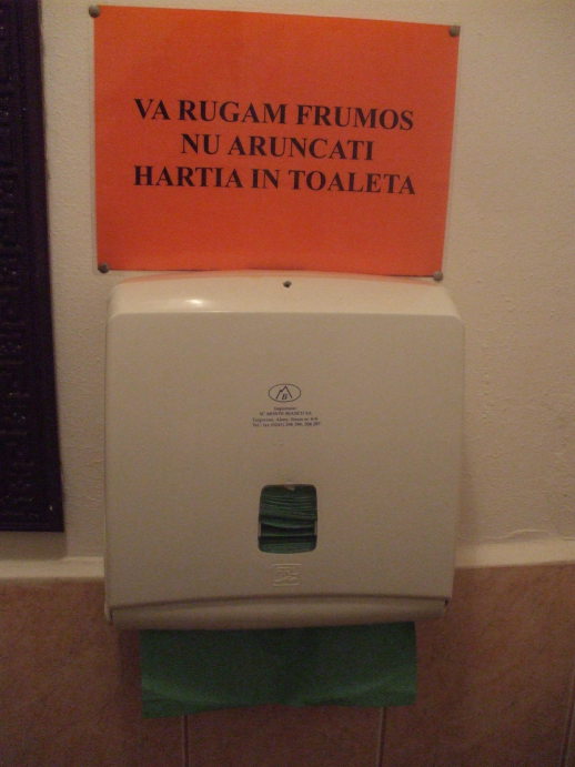Hand towels and sign in a restaurant in Bistriţa, Romania.