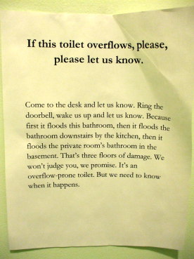 Warning sign about a flooding toilet.