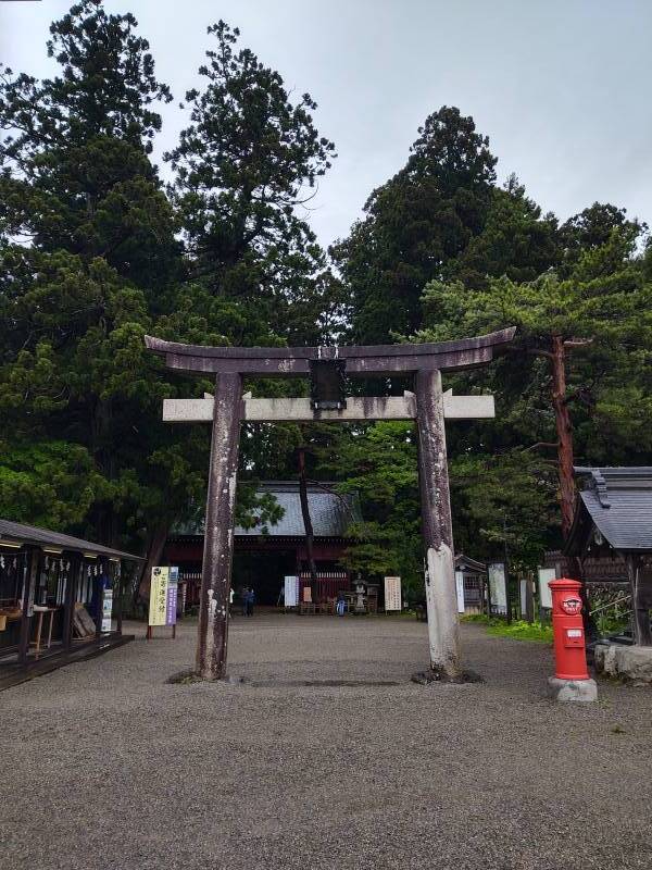 Large torii or Shintō gate and Buddhist Zuishin-mon gate at the entrance to the Mount Haguro trail.