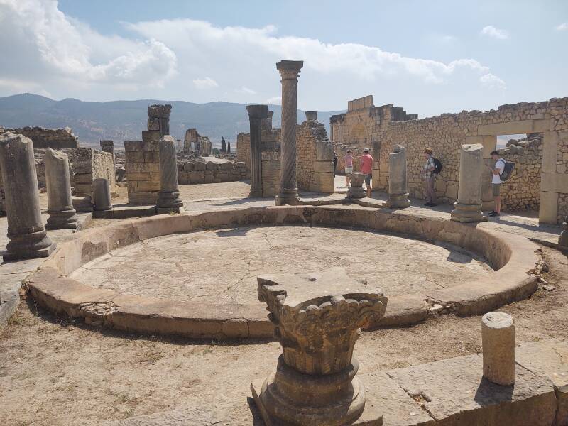 Triumphal arch and House of Columns with its large round basin at Volubilis.